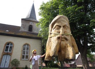 Bildhauer Magnus Kleine-Tebbe und seine Skulptur „Christuskopf“ vor der Kirche in Salzgitter-Lesse. Foto: Stiftung Prüsse/Susanne Hübner