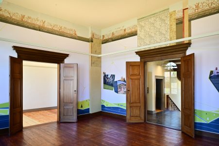 Innenraum mit einem gemalten Fries und historischer Tapete über der Tür. Foto: Andreas Greiner-Napp