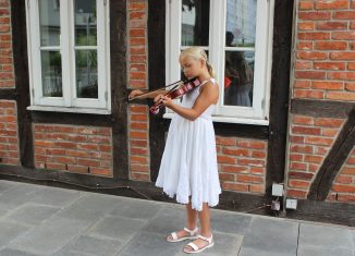 Jil probiert ihre neue Geige aus – die Elfjährige kann nur dank einer speziellen Hörprothese etwas hören. Foto: Aktion Kindertraum